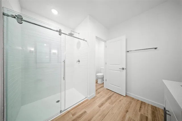 a bathroom with a shower and a glass door