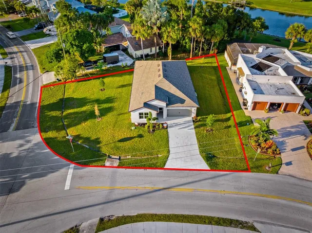 an aerial view of a house with a garden and parking space