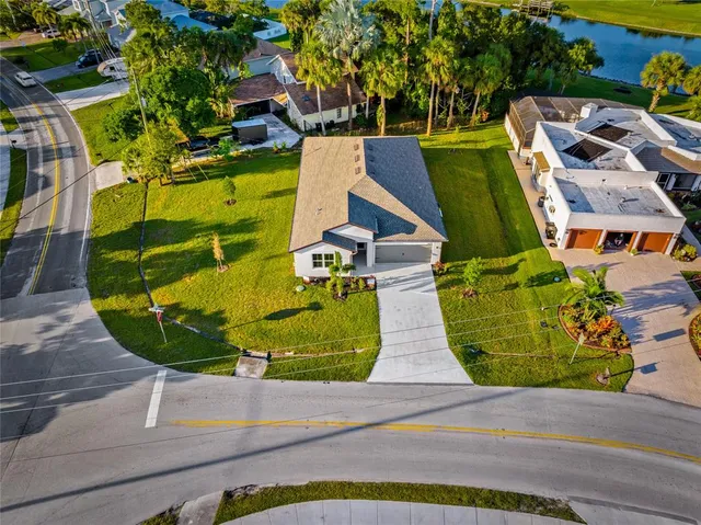 an aerial view of a house with a garden and trees