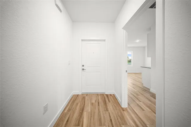 a view of a room with wooden floor
