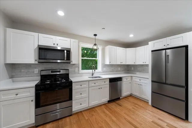 a kitchen with a refrigerator stove and microwave