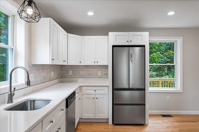 a kitchen with stainless steel appliances granite countertop a refrigerator sink and cabinets