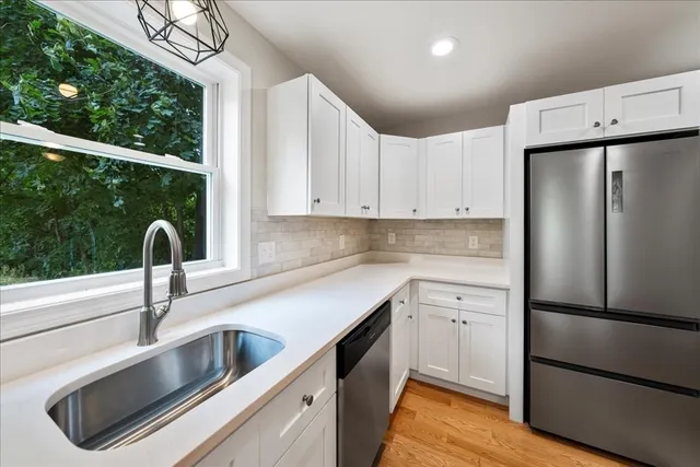 a kitchen with stainless steel appliances granite countertop a refrigerator sink and cabinets
