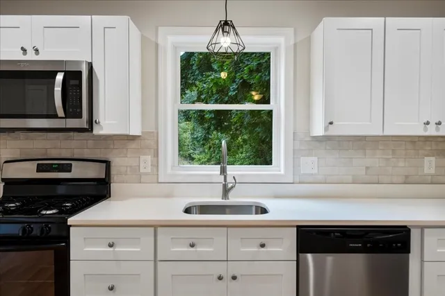 a kitchen with a sink and cabinets