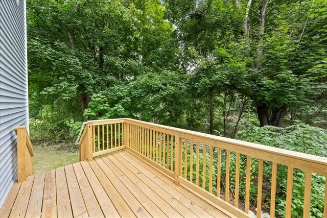 a view of balcony with wooden floor and fence
