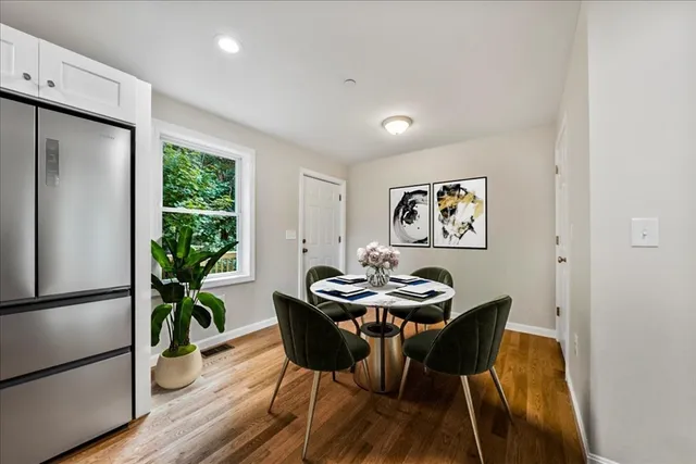 a view of a dining room with furniture window and wooden floor