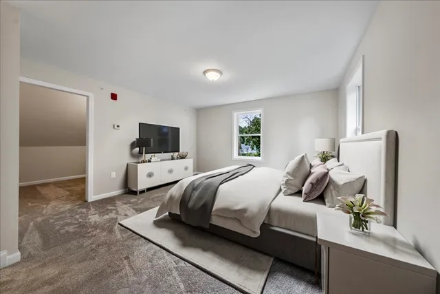 a bedroom with a bed and flat screen tv