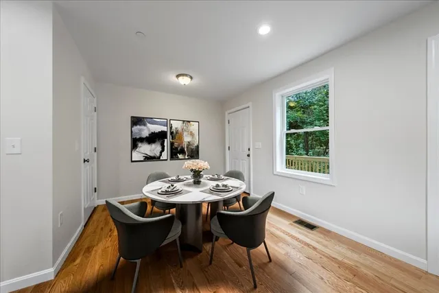 a dining room with furniture and window
