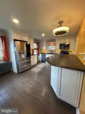 a kitchen with refrigerator and window