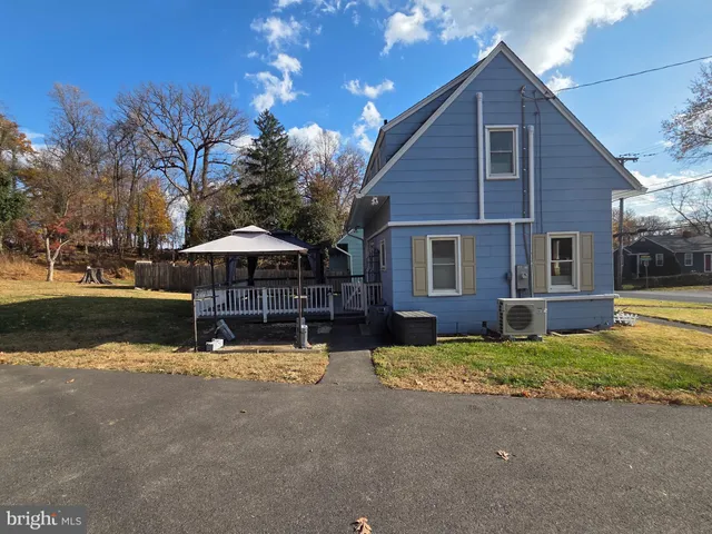 a view of a house with pool and sitting area