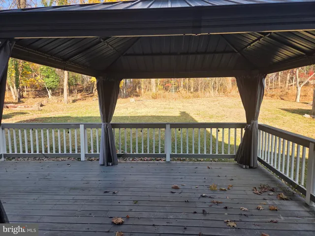 a view of porch with wooden floor