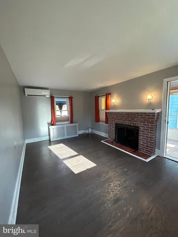a view of empty room with a fireplace