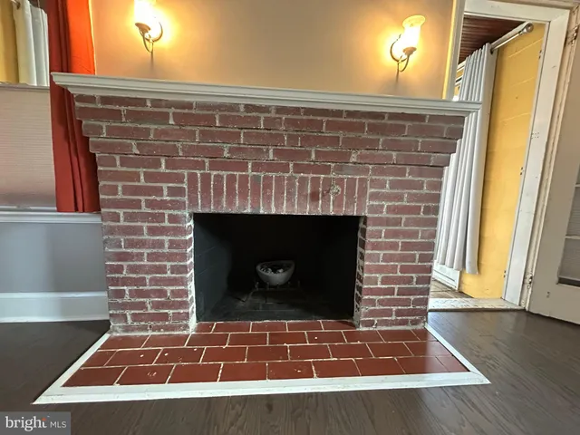 a stone fireplace with a rug