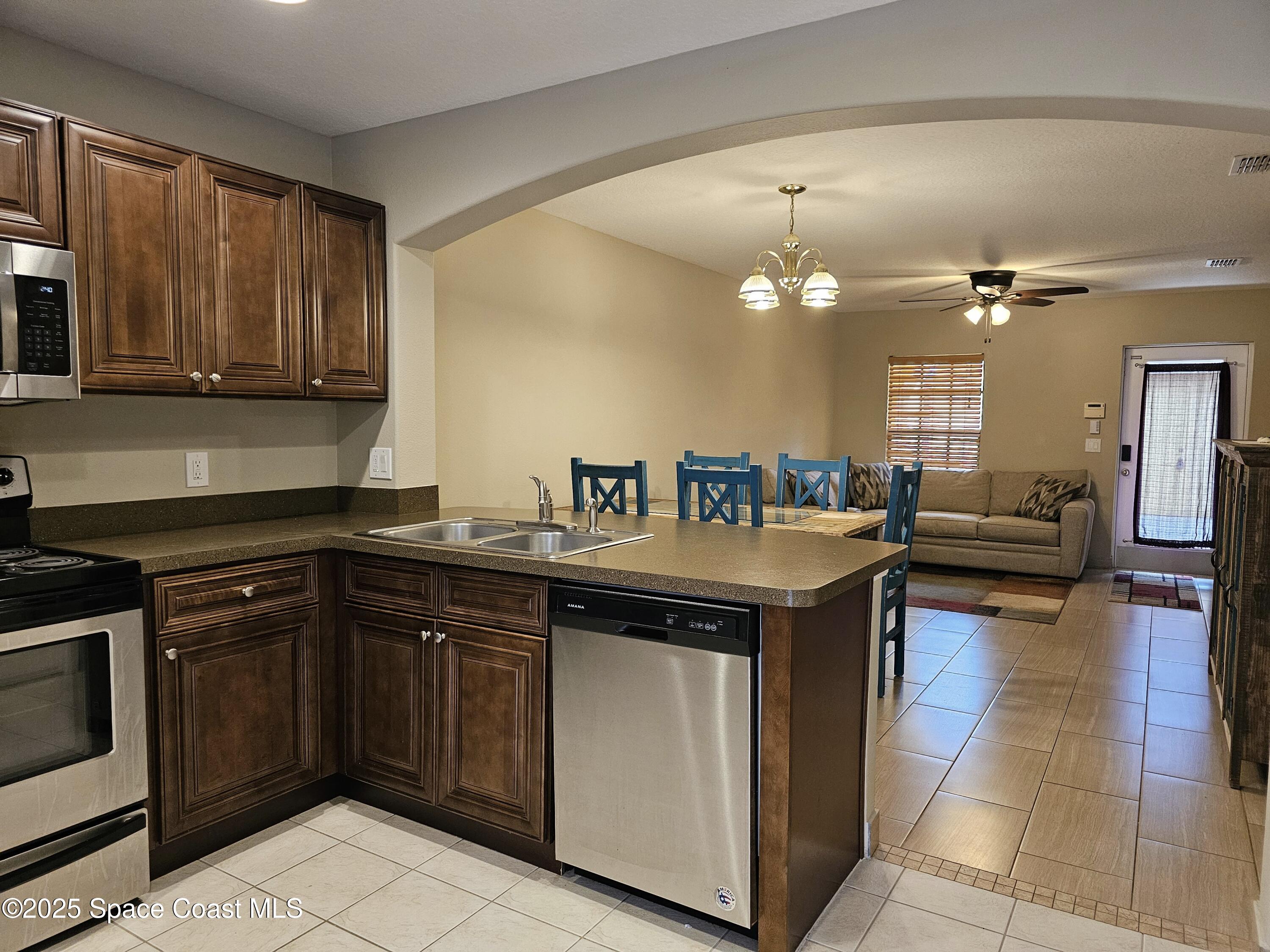 4570 Radiant Way, Unit 104 Melbourne, FL 32901 - Photo 12 of 41 a kitchen with a stove sink and cabinets