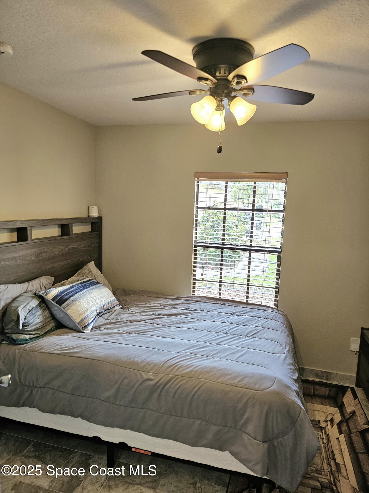 4570 Radiant Way, Unit 104 Melbourne, FL 32901 - Photo 14 of 41 a bedroom with a bed and window