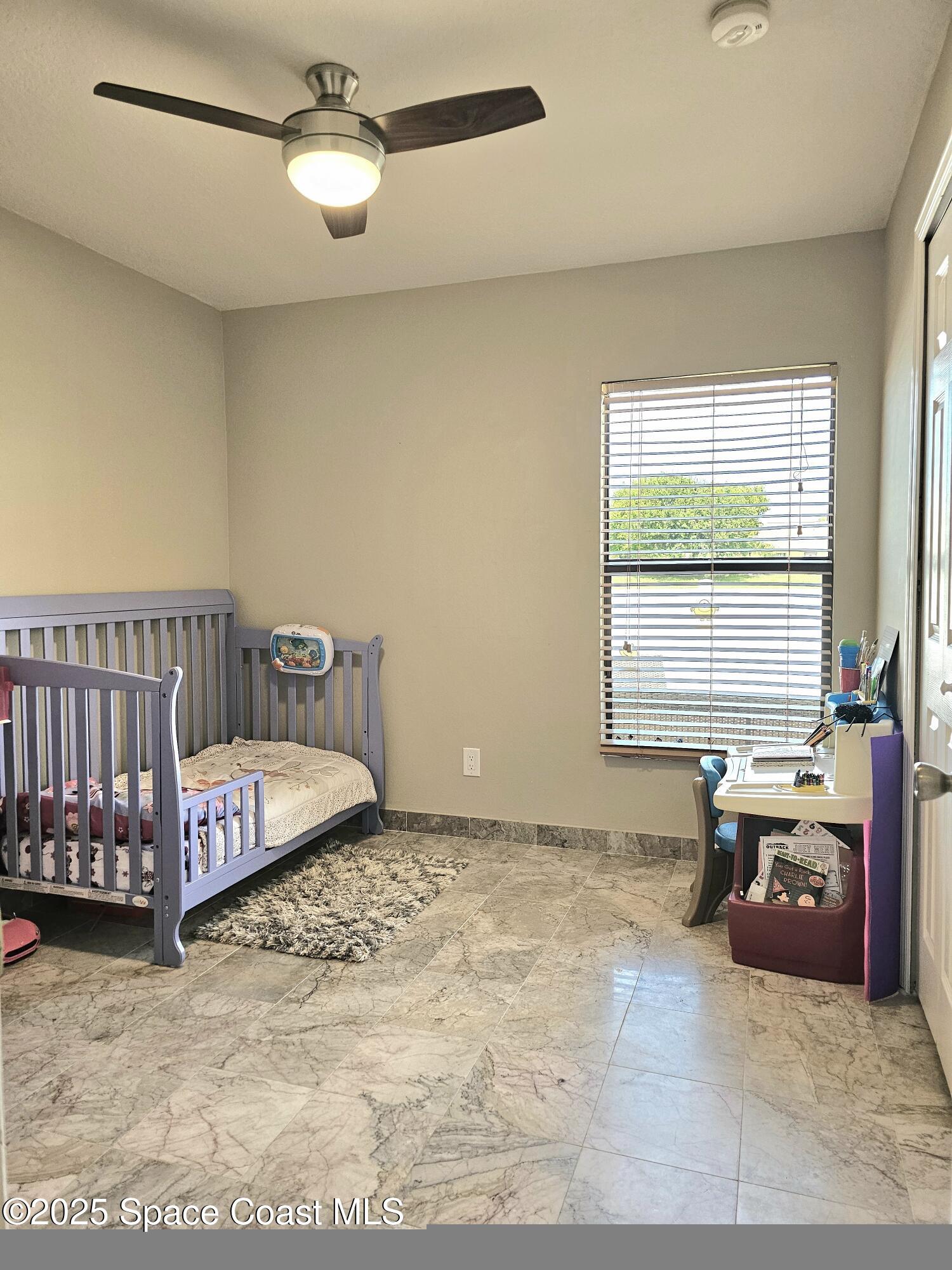4570 Radiant Way, Unit 104 Melbourne, FL 32901 - Photo 18 of 41 a spacious bedroom with a bed and a table