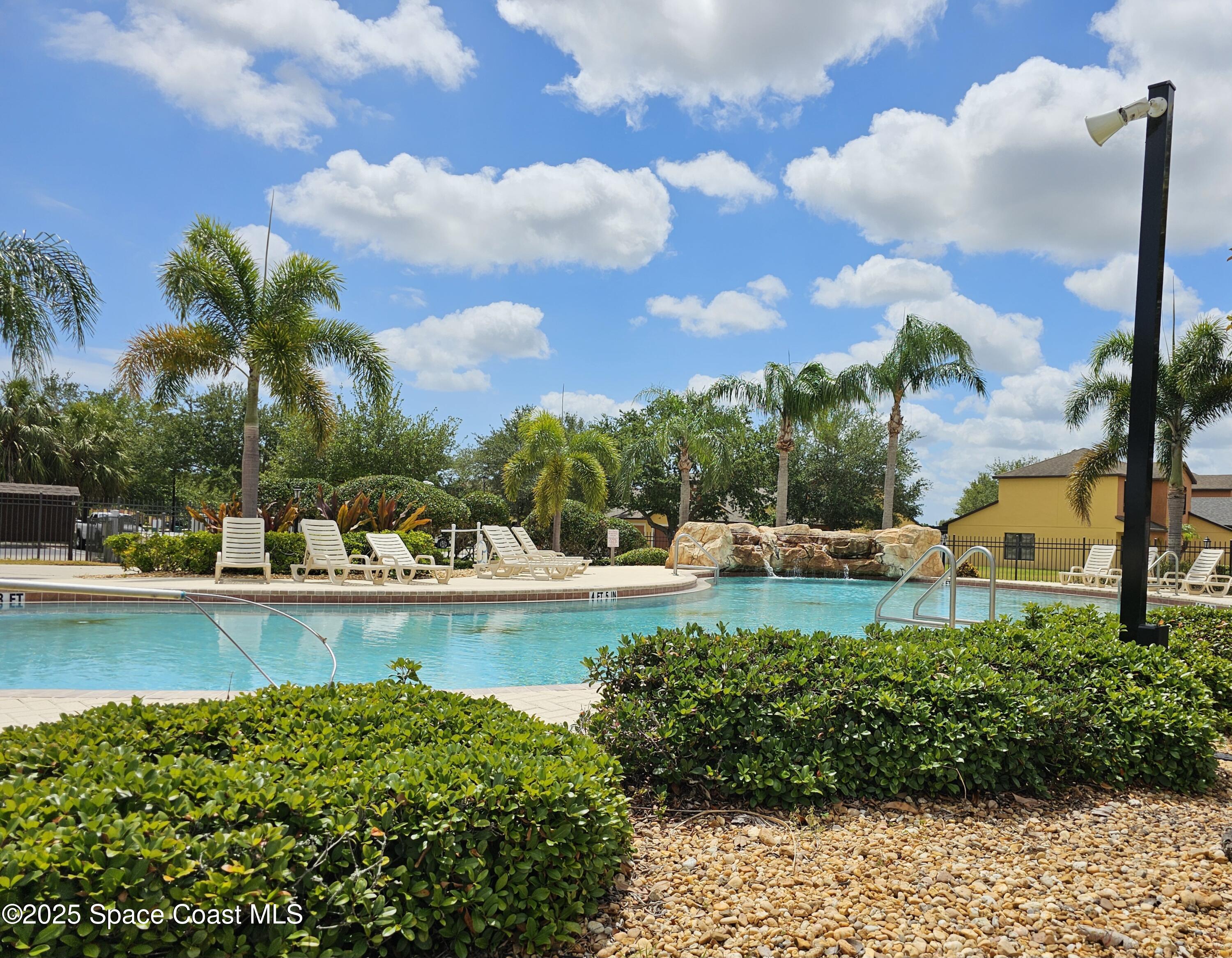 4570 Radiant Way, Unit 104 Melbourne, FL 32901 - Photo 31 of 41 a view of a swimming pool and lounge chair
