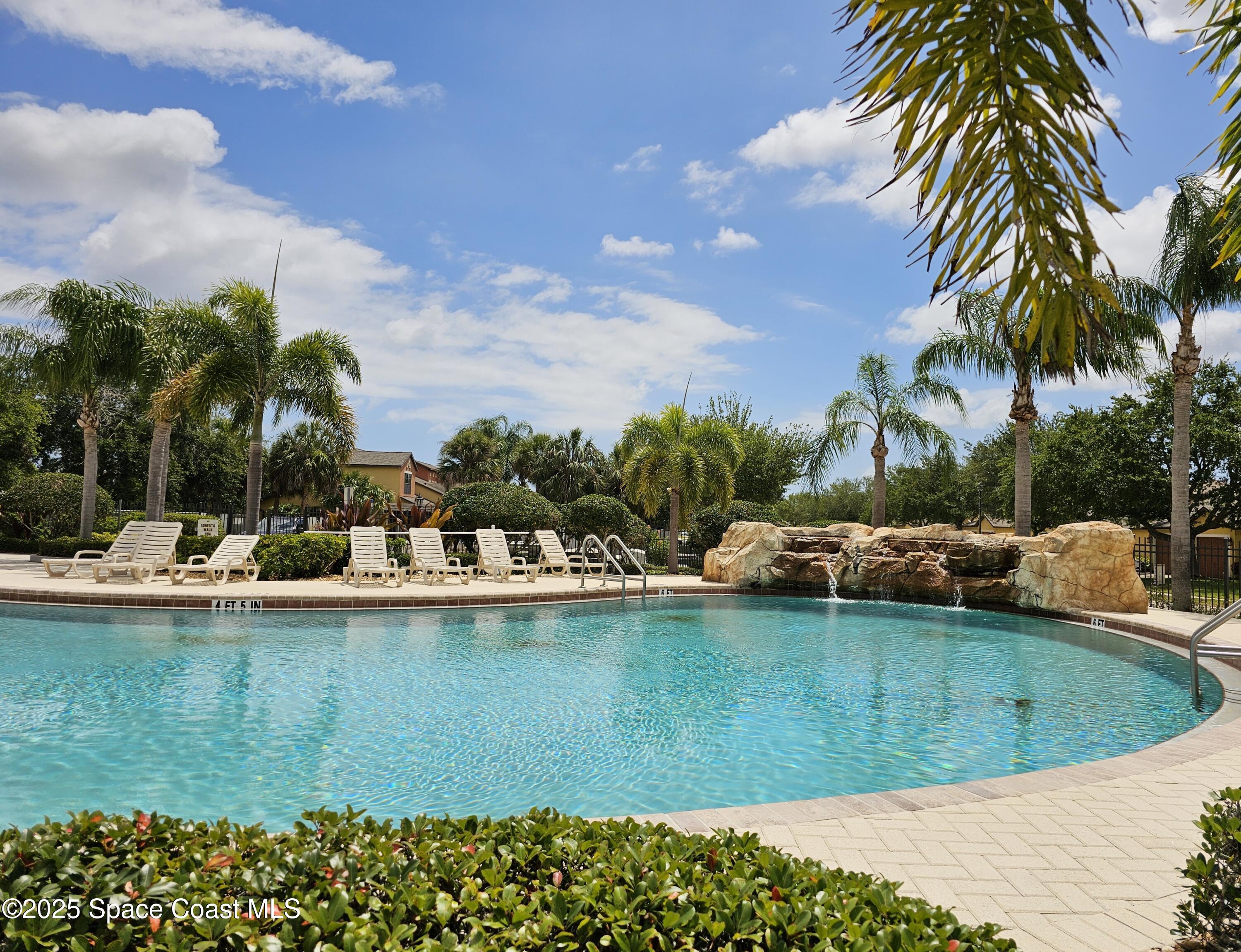 4570 Radiant Way, Unit 104 Melbourne, FL 32901 - Photo 32 of 41 a view of a swimming pool and a chair