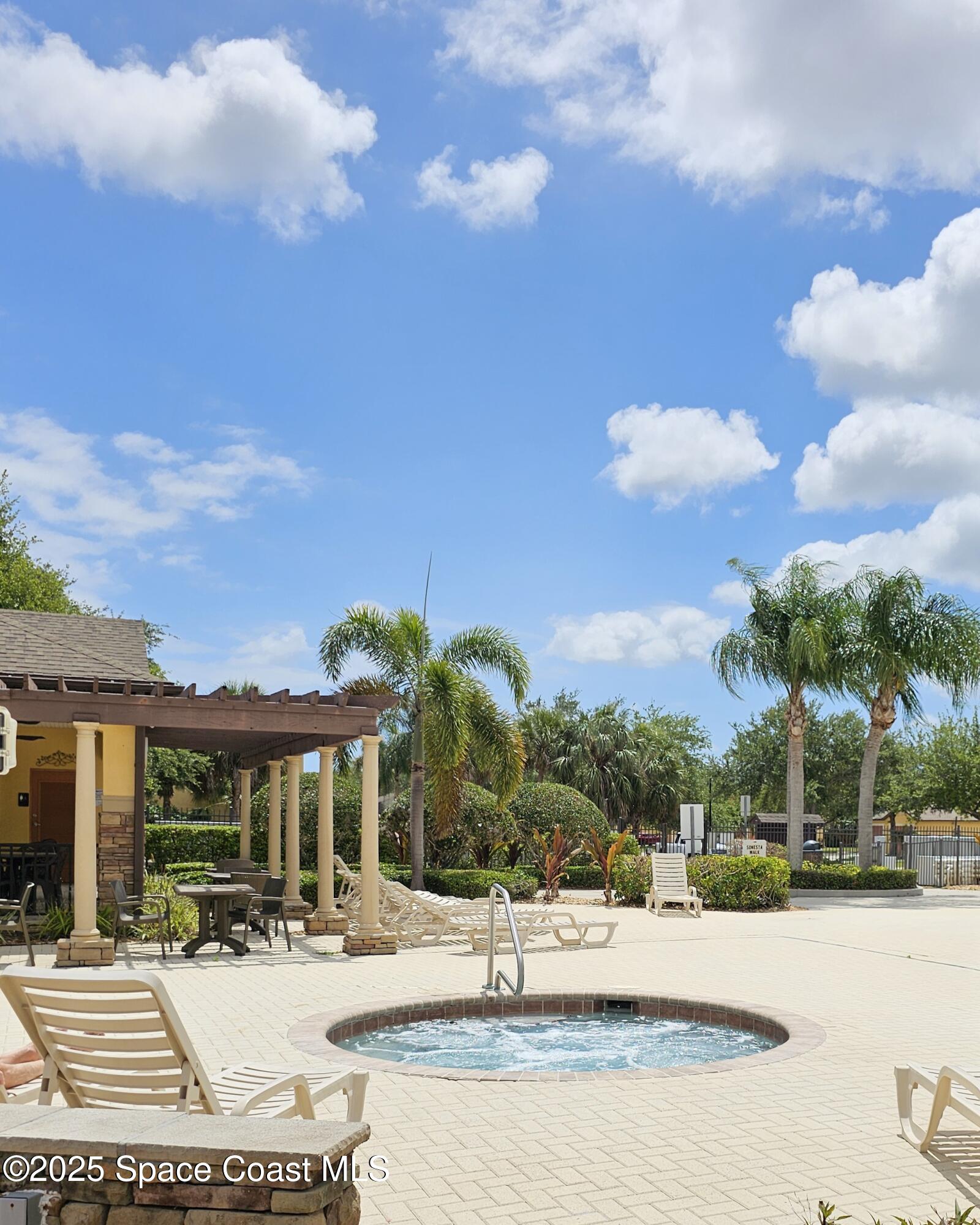 4570 Radiant Way, Unit 104 Melbourne, FL 32901 - Photo 35 of 41 a view of a house with outdoor space and sitting area