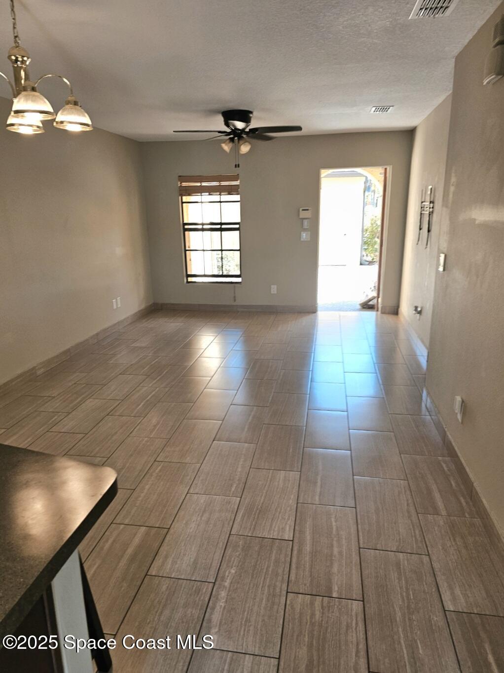 4570 Radiant Way, Unit 104 Melbourne, FL 32901 - Photo 6 of 41 a view of an empty room and window