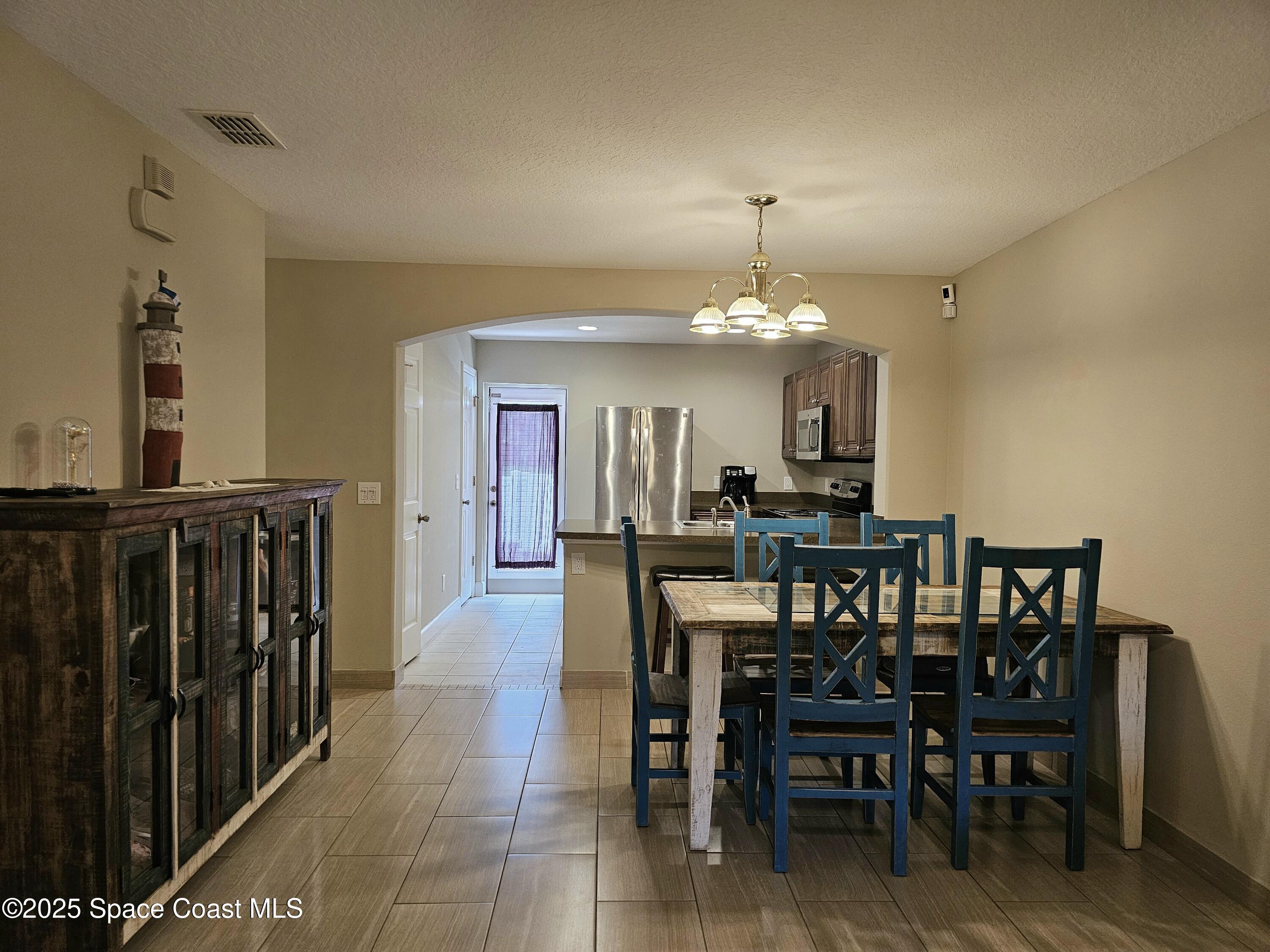4570 Radiant Way, Unit 104 Melbourne, FL 32901 - Photo 7 of 41 a view of a dining room with furniture