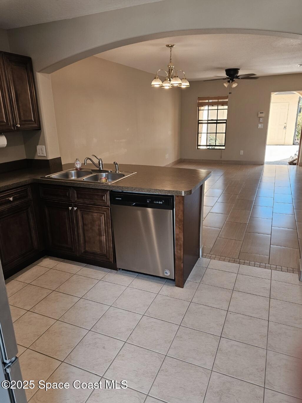 4570 Radiant Way, Unit 104 Melbourne, FL 32901 - Photo 10 of 41 a kitchen with stainless steel appliances a sink a counter space and cabinets