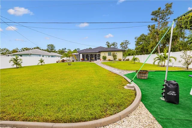 a backyard of a house with table and chairs