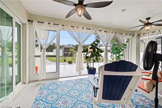 a living room with furniture and flower pot