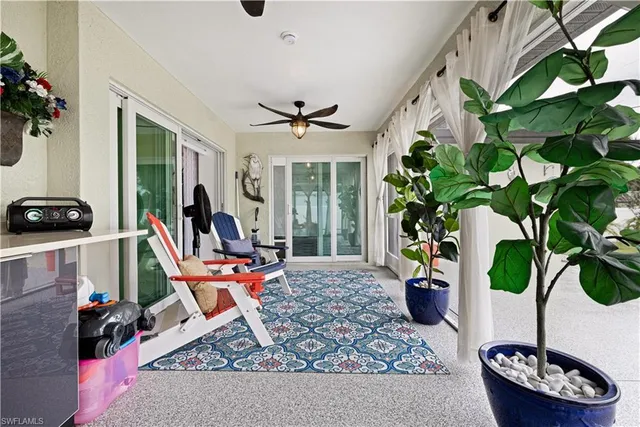 a living room with furniture large window and a fireplace