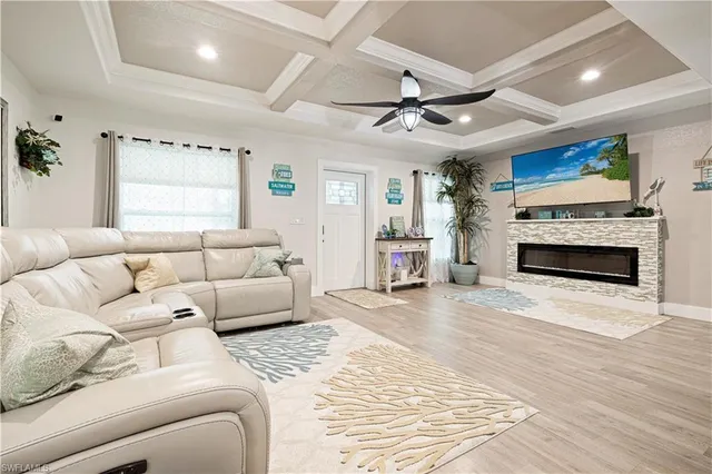 a large bedroom with a large bed and ceiling fan