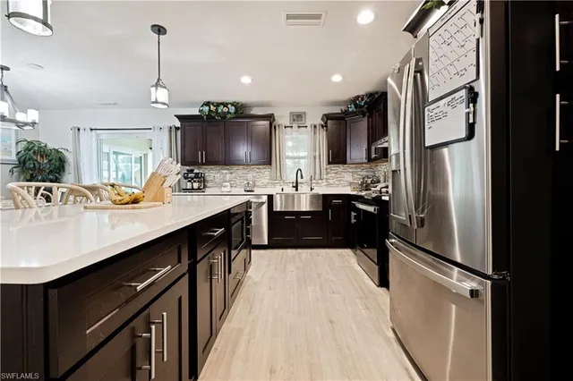a kitchen with a sink stainless steel appliances and cabinets
