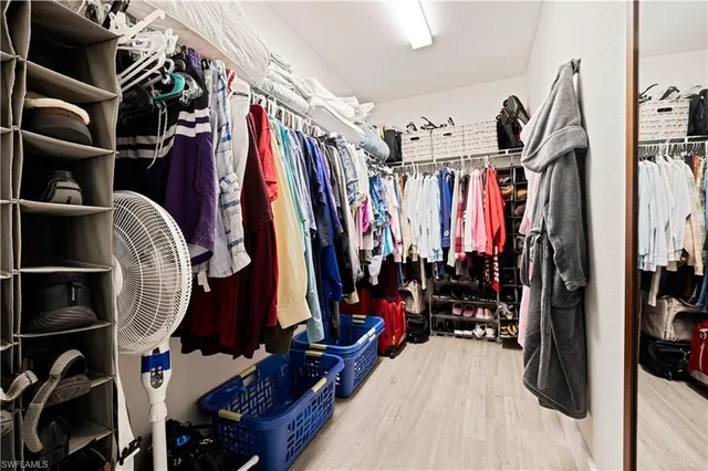 a bedroom with a bed and a flat tv screen