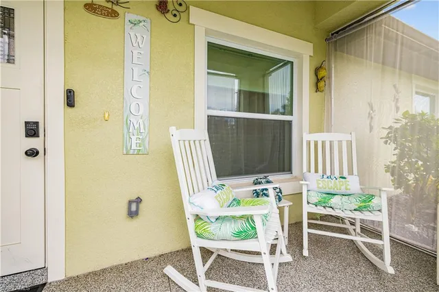 a porch with a table and chairs