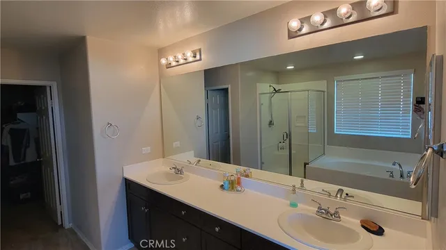 a bathroom with a granite countertop sink a toilet and shower