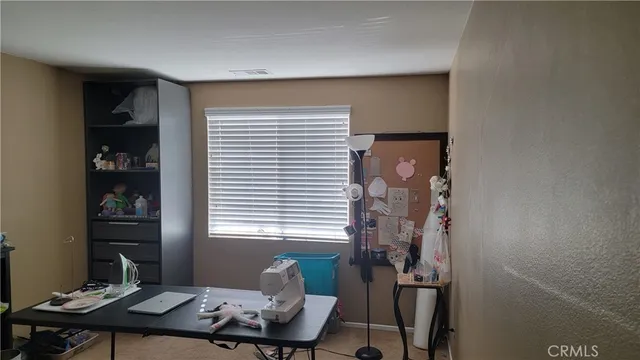 a view of a hallway to a livingroom with wooden floor and stairs