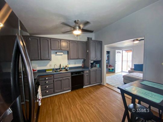333 North Helena Street Ridgecrest, CA 93555 - Photo 7 of 35 a kitchen with kitchen island a stove a sink and a refrigerator