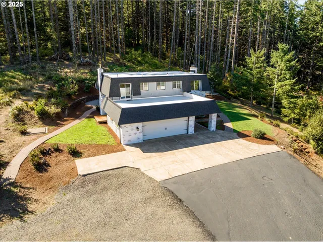 an aerial view of a house with a yard basket ball court and outdoor seating