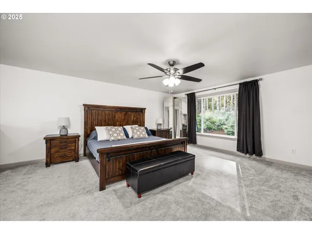 a spacious bedroom with a bed window and a couch