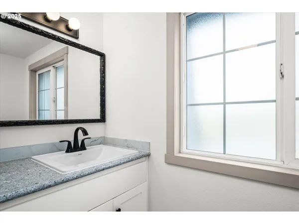 a bathroom with a glass shower door