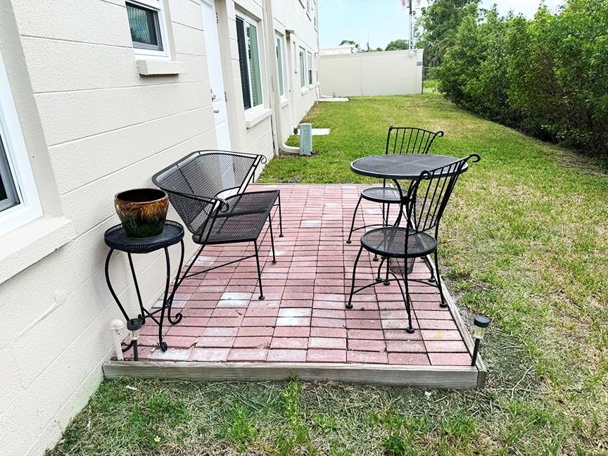 4455 Duhme Road, Unit 103 St. Petersburg, FL 33708 - Photo 26 of 37 a view of a chairs and table in backyard of the house