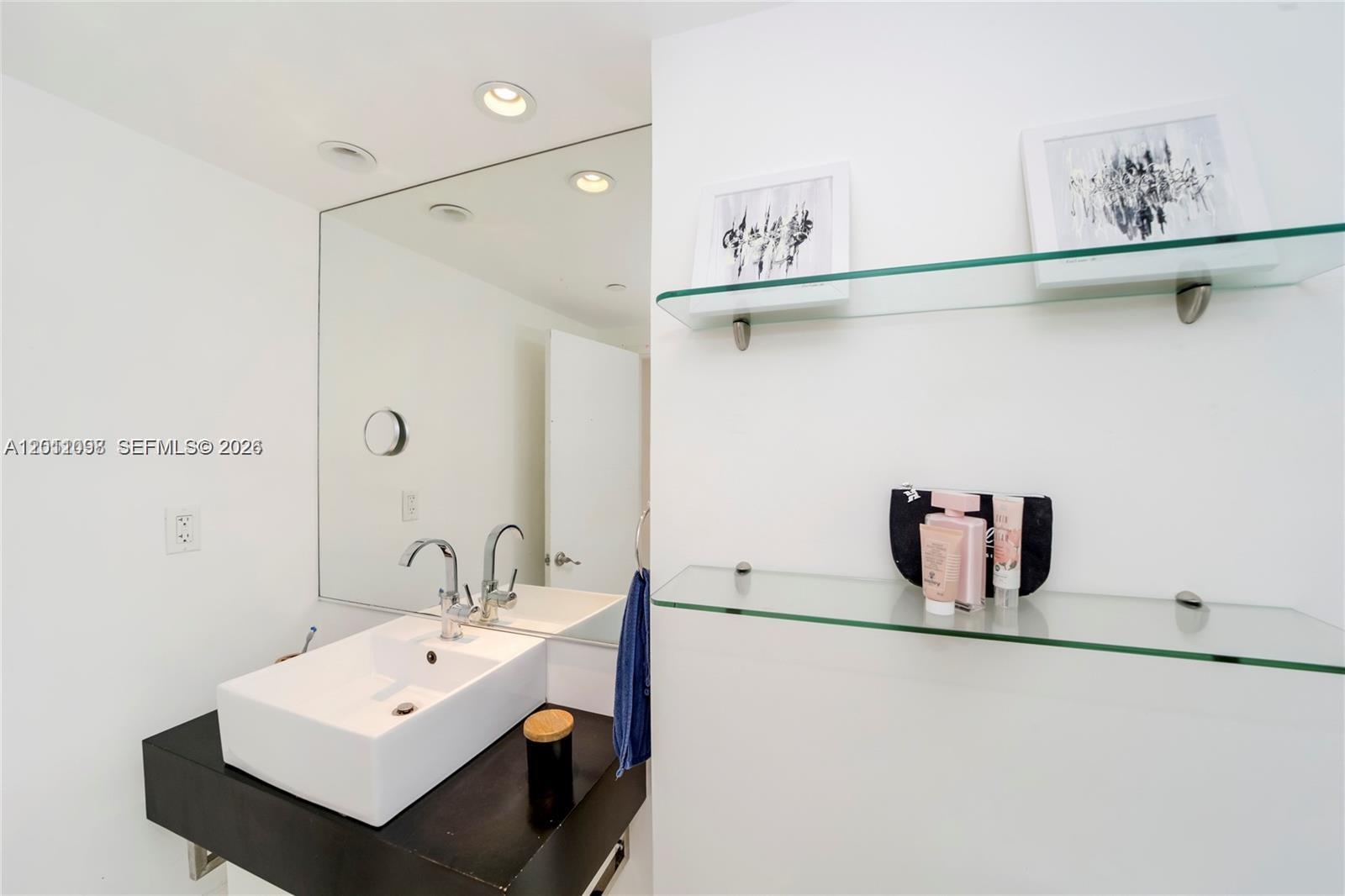 100 Lincoln Road, Unit 605 Miami Beach, FL 33139 - Photo 11 of 17 a bathroom with a sink and mirror