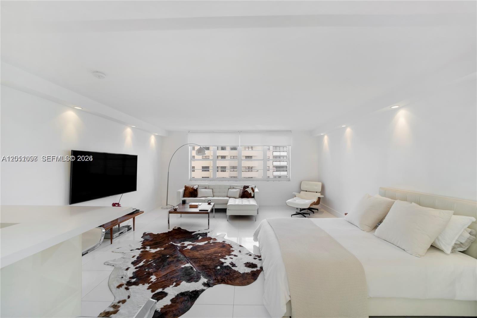 100 Lincoln Road, Unit 605 Miami Beach, FL 33139 - Photo 3 of 17 a bed room with a bed window and a flat screen tv
