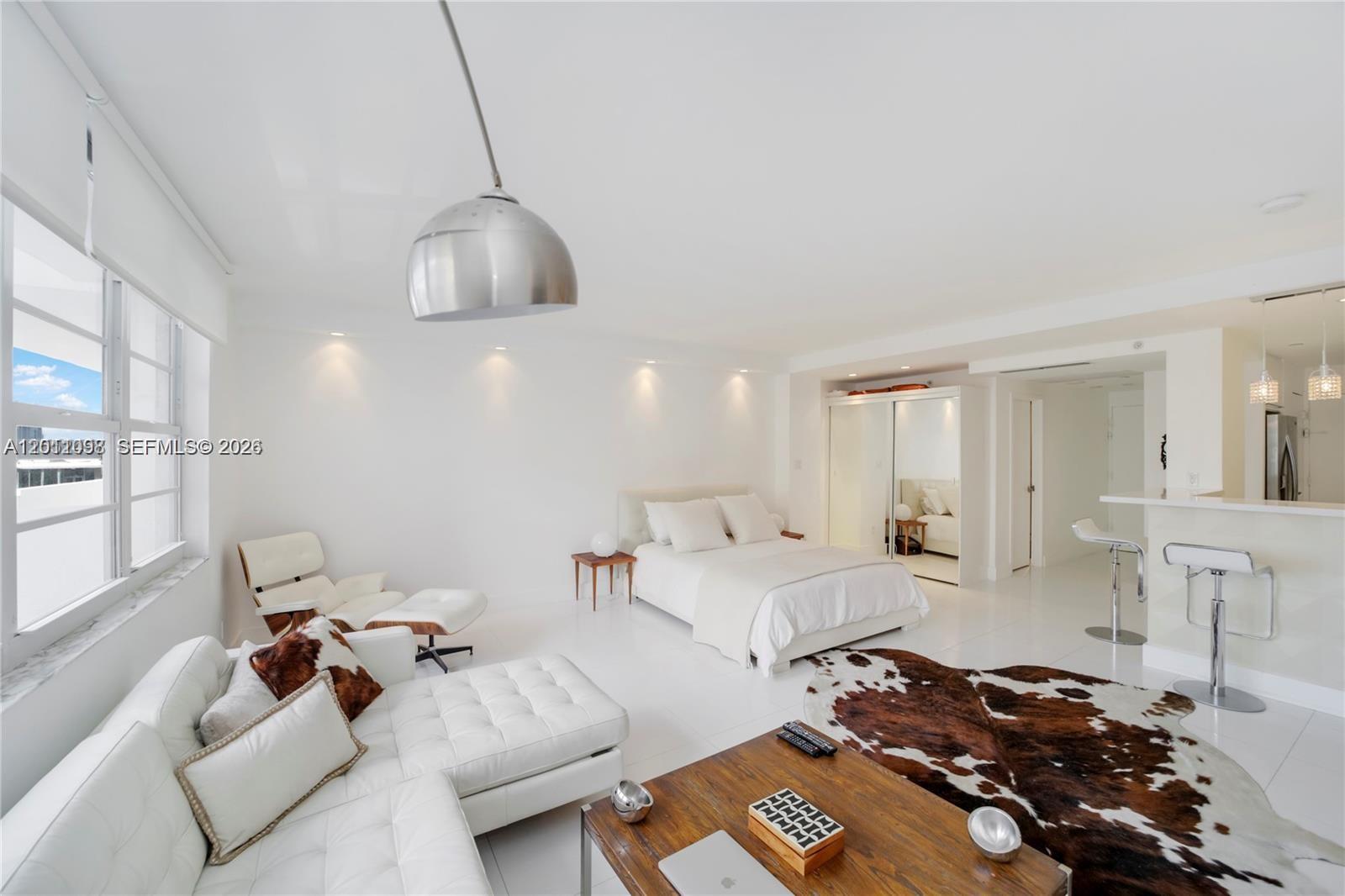 100 Lincoln Road, Unit 605 Miami Beach, FL 33139 - Photo 5 of 17 a room with furniture or couch and a chandelier