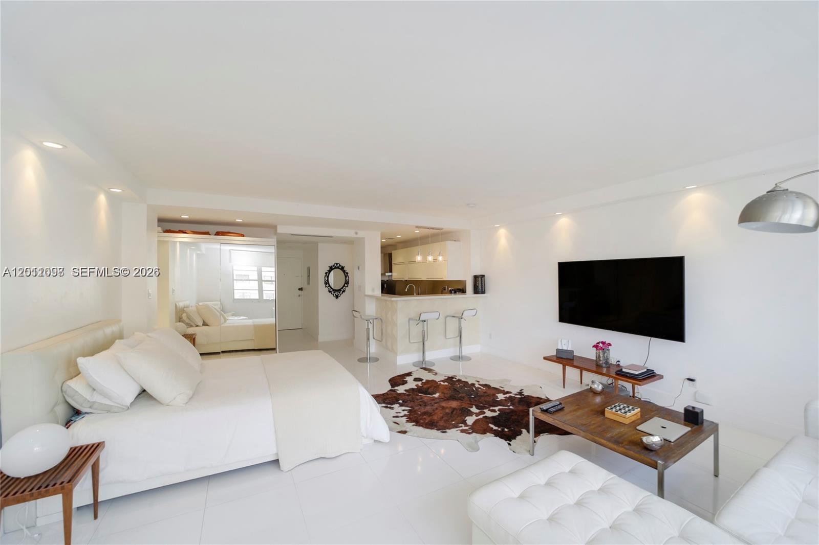 100 Lincoln Road, Unit 605 Miami Beach, FL 33139 - Photo 6 of 17 a living room with furniture and a flat screen tv