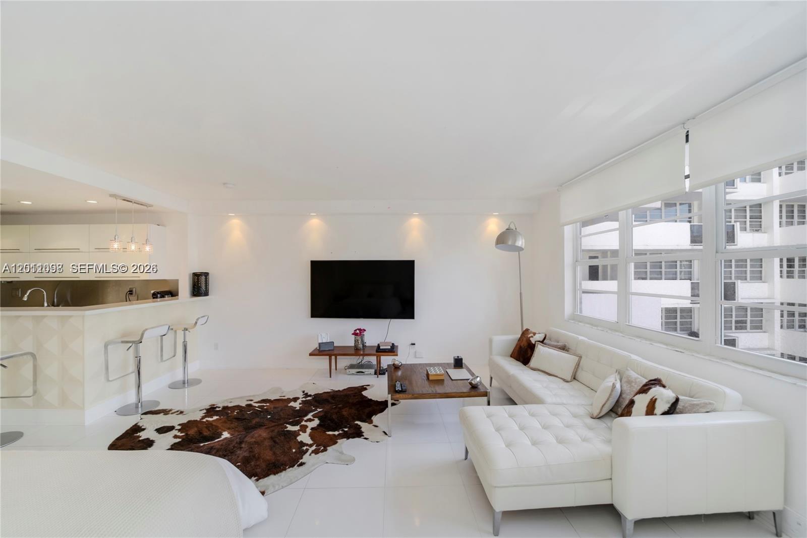 100 Lincoln Road, Unit 605 Miami Beach, FL 33139 - Photo 7 of 17 a living room with furniture and a flat screen tv