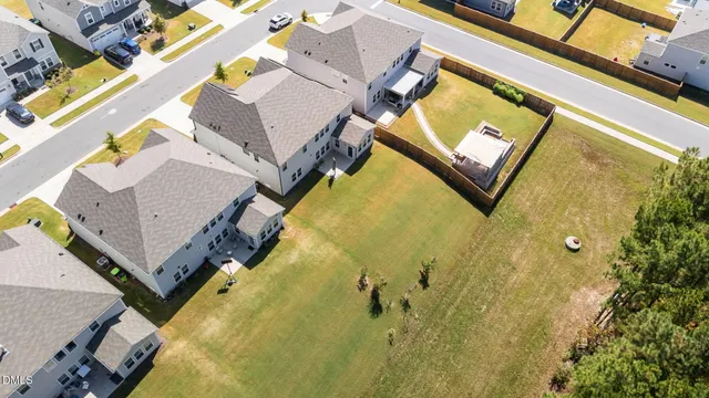 a backyard of a house with yard table and chairs