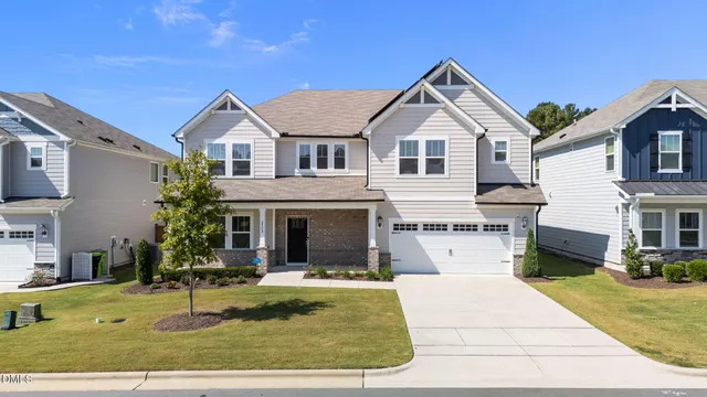 a view of house with yard and swimming pool