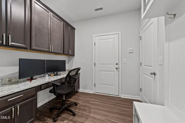 a kitchen with stainless steel appliances granite countertop a sink refrigerator and cabinets
