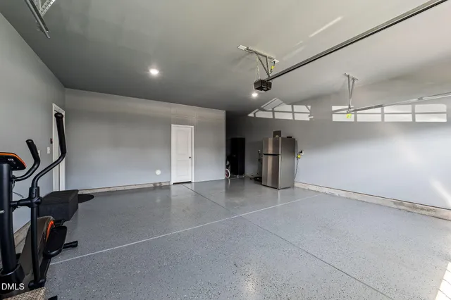 a large kitchen with stainless steel appliances kitchen island granite countertop a large counter top a stove and a sink