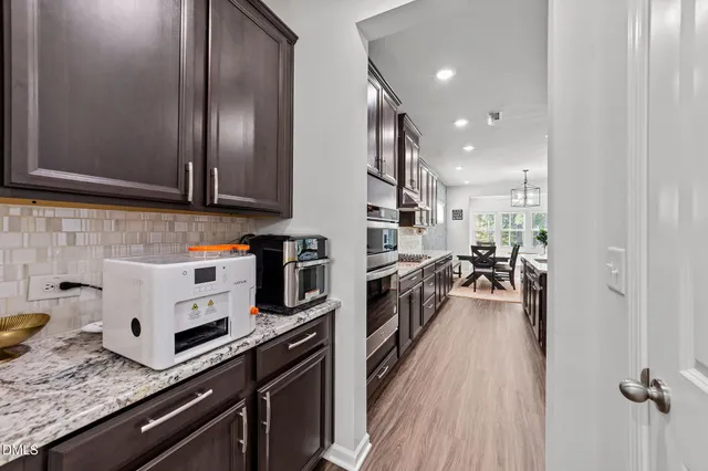 a bathroom with a sink a toilet a mirror and shower